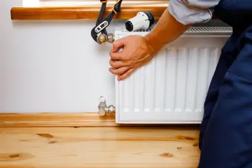 Plumber Installing Heating System