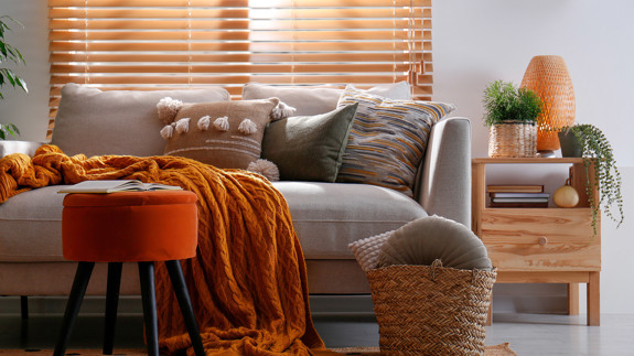 Sofa Layered With Cushions And Blankets