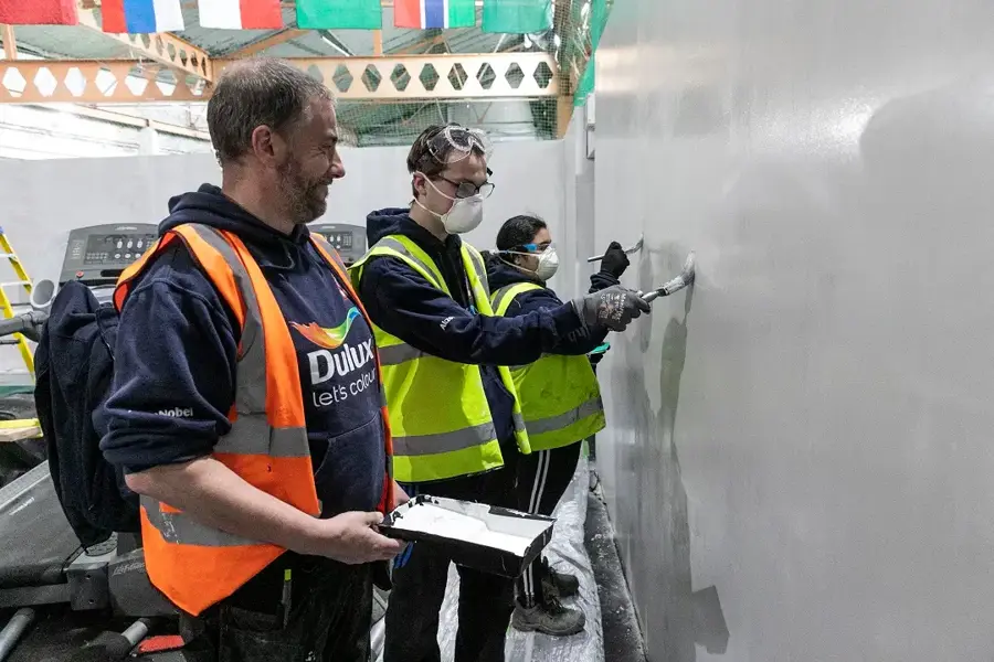 Group Of Young People Practice Their Plastering Skills