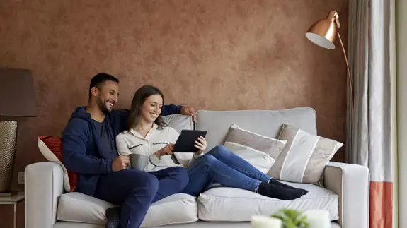 Couple Sat Together On Sofa